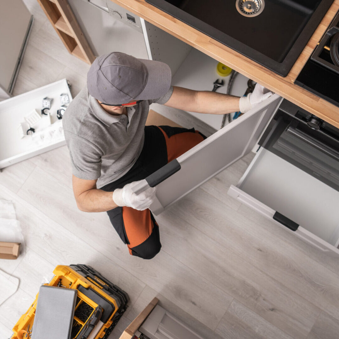 Kitchen Cabinetmaker Installing Furniture Inside a Apartment Professional Kitchen Cabinetmaker Installing Furniture Inside a Apartment